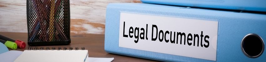 Legal Documents Labeled in blue documents organizer under the wooden table