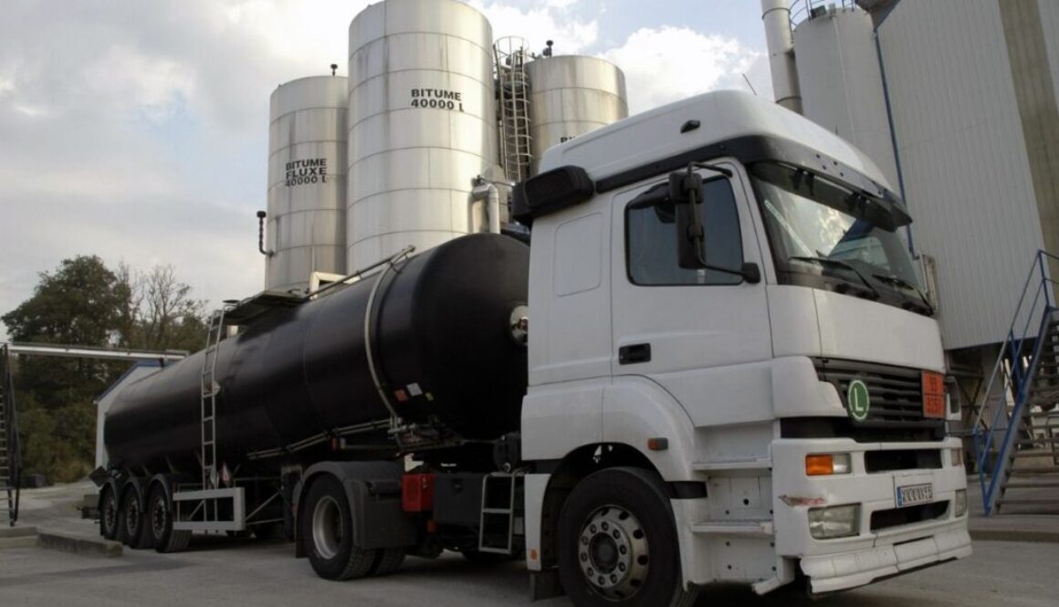 Tanker truck parked at the outside of factory