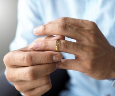 A man holding his wedding band while thinking about getting an annulment in Indiana.