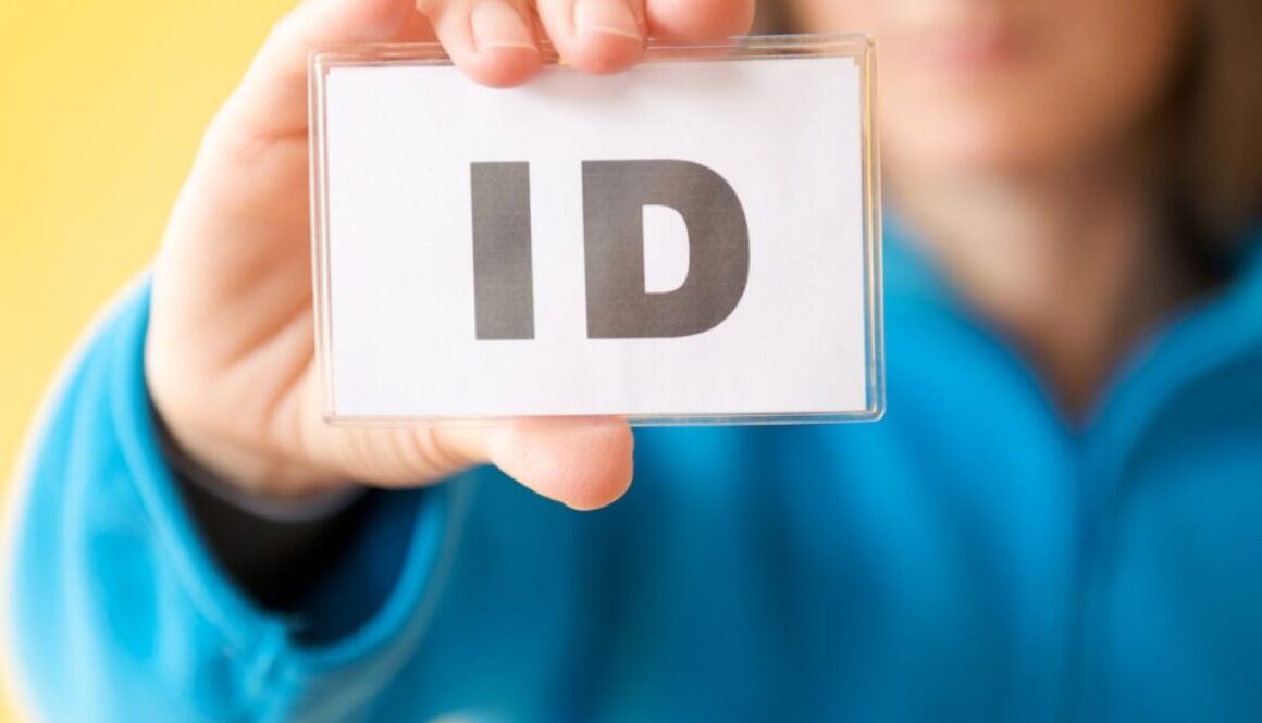 A man showing a card with the words ID on it.