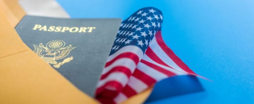 A passport on top of the American flag.