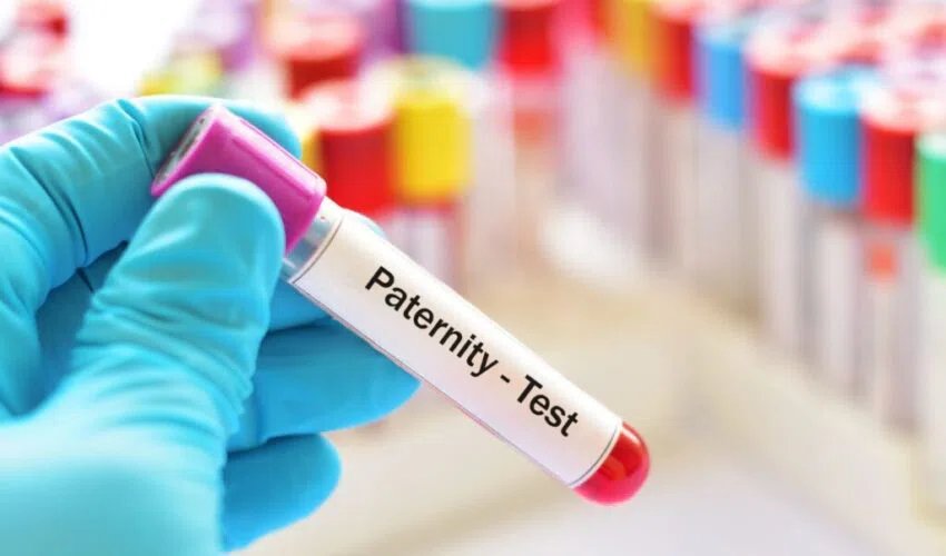 A chemist holding a paternity test sample. 