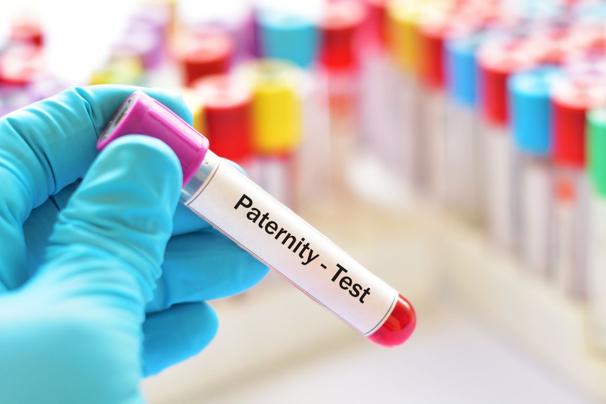 A chemist holding a paternity test sample.