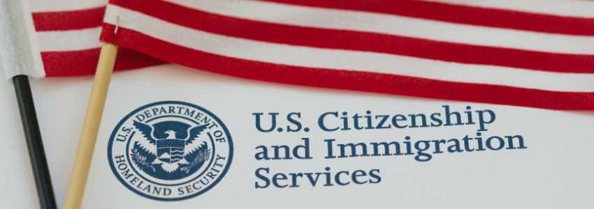 US citizenship and immigration services form and two American flags as proof of citizenship